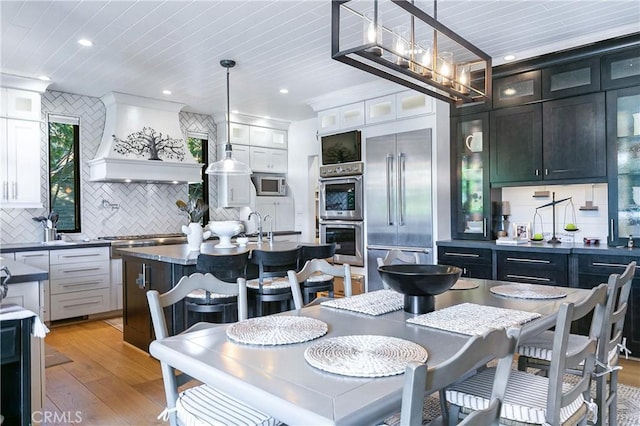 dining space featuring sink and light hardwood / wood-style floors