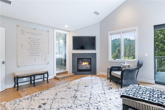 sitting room featuring hardwood / wood-style flooring and lofted ceiling