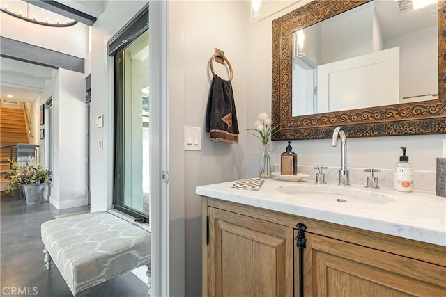 bathroom featuring vanity, a wealth of natural light, and concrete flooring