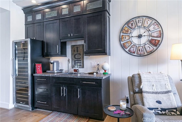 kitchen featuring wine cooler, sink, stainless steel fridge, and light hardwood / wood-style floors