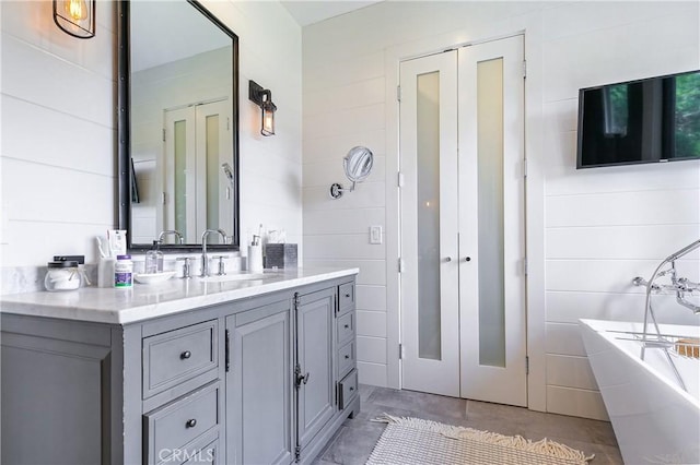 bathroom with vanity and a bathtub