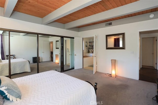 bedroom featuring beamed ceiling, carpet flooring, and wood ceiling