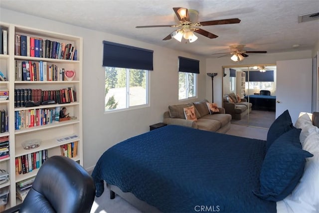 bedroom featuring ceiling fan and a closet