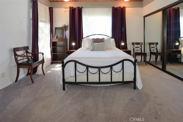 bedroom featuring light colored carpet and wooden ceiling