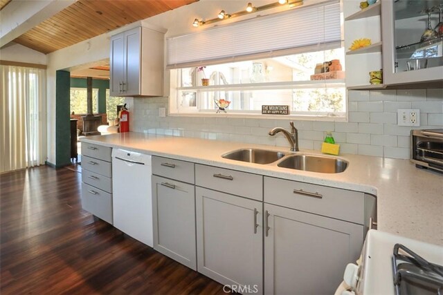 kitchen featuring sink, range, dark hardwood / wood-style flooring, dishwasher, and decorative backsplash