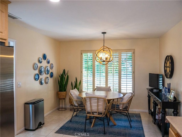 dining space featuring a notable chandelier and light tile patterned floors