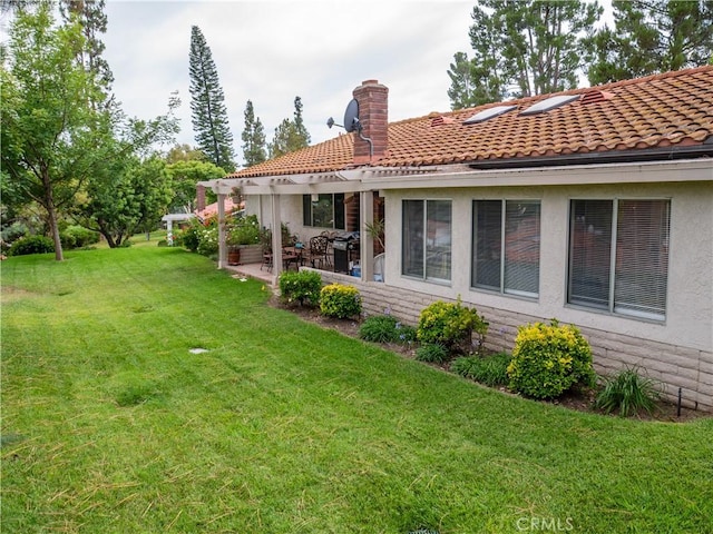 rear view of property featuring a yard