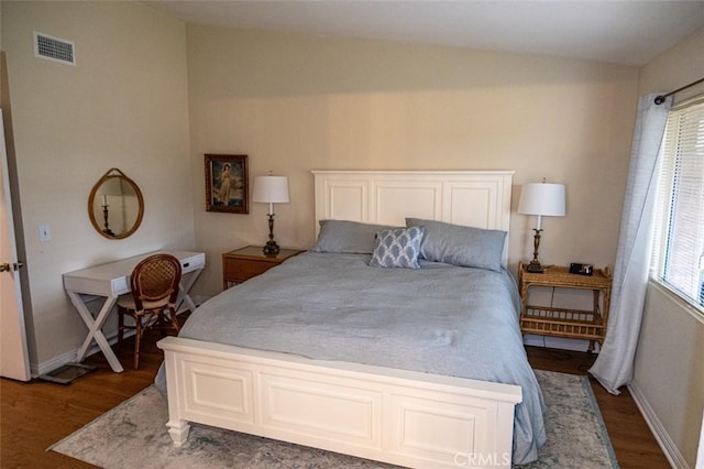 bedroom featuring wood-type flooring and vaulted ceiling