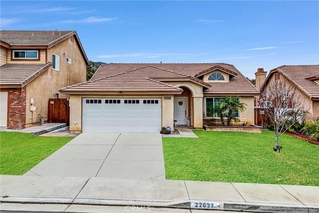 view of front of property featuring a garage and a front lawn