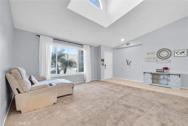 sitting room with light colored carpet and vaulted ceiling