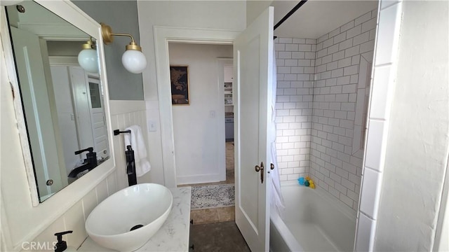 bathroom with vanity and tiled shower / bath combo