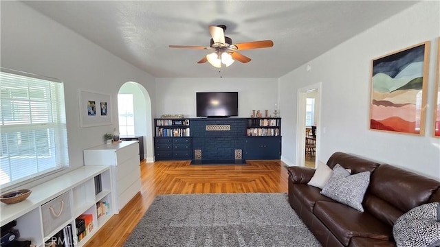 living room with ceiling fan and light wood-type flooring