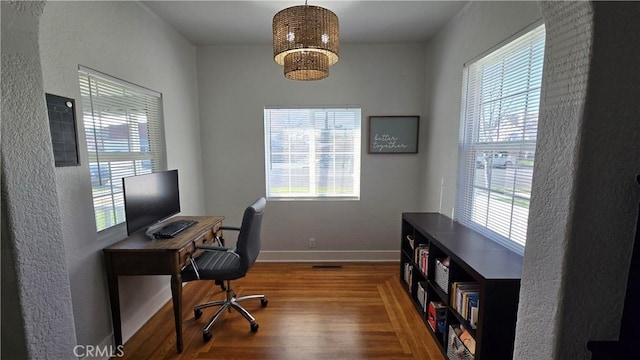 office space with hardwood / wood-style flooring and a chandelier