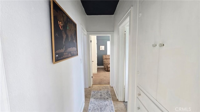 corridor with light tile patterned floors