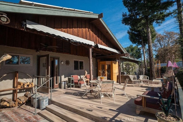 wooden deck with ceiling fan and a patio