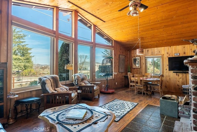 sunroom / solarium featuring vaulted ceiling, wooden ceiling, and ceiling fan