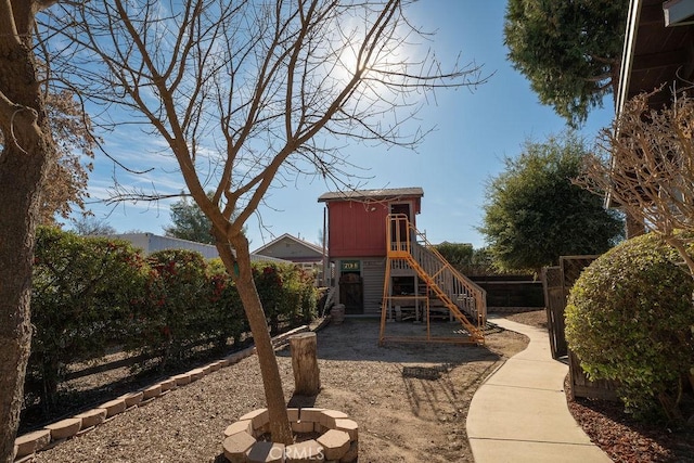 view of play area with an outdoor fire pit