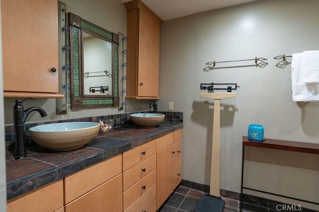 bathroom with tasteful backsplash and vanity