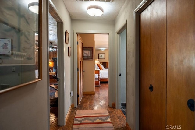 hallway featuring dark wood-type flooring