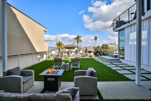 view of patio / terrace with an outdoor living space with a fire pit