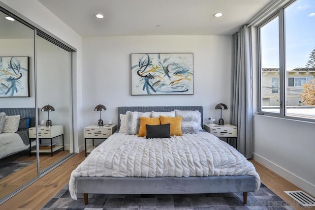 bedroom with a closet and dark hardwood / wood-style floors