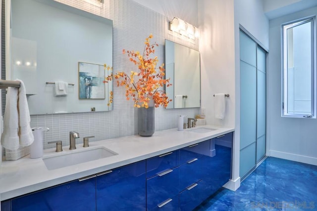 bathroom featuring concrete flooring, vanity, and backsplash