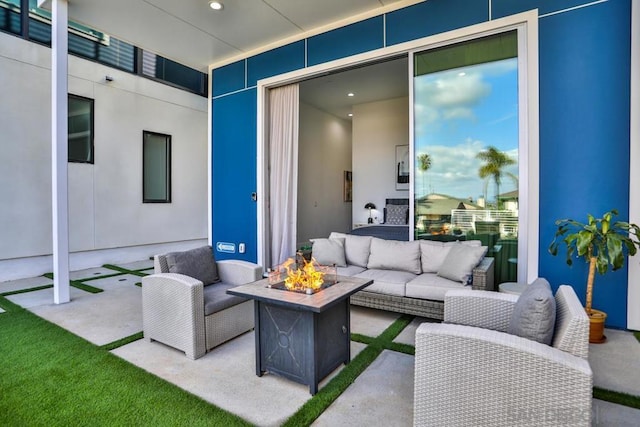 view of patio / terrace with an outdoor living space with a fire pit