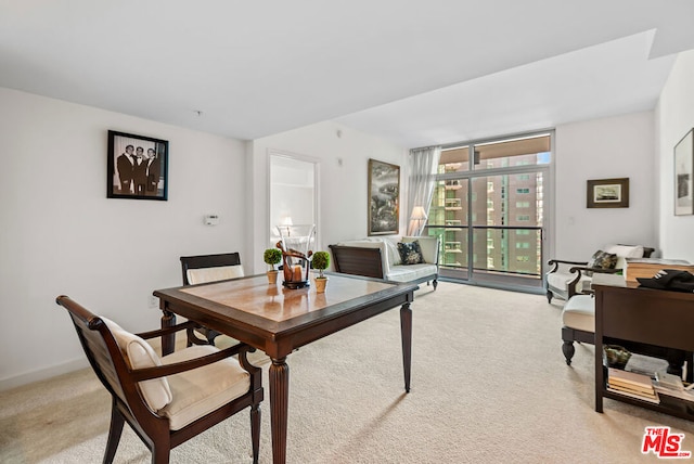 carpeted dining area with a wall of windows