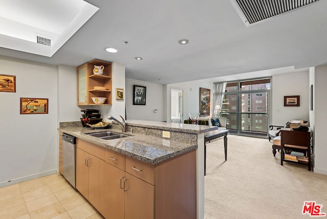 kitchen featuring stone counters, light tile patterned flooring, sink, stainless steel dishwasher, and kitchen peninsula