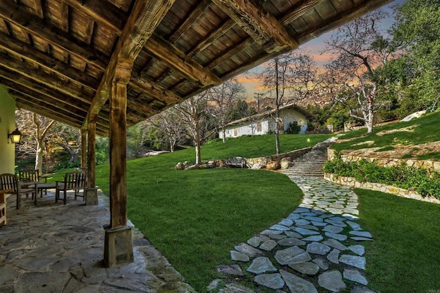 view of home's community with a lawn and a patio