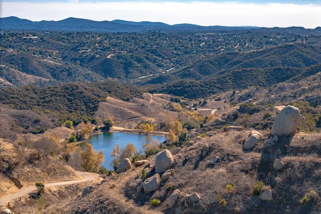 aerial view featuring a water and mountain view