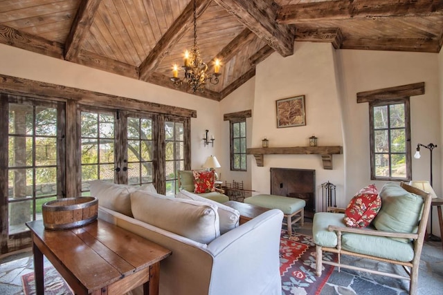 living area featuring wood ceiling, a fireplace, beamed ceiling, and french doors