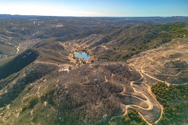 birds eye view of property featuring a water and mountain view