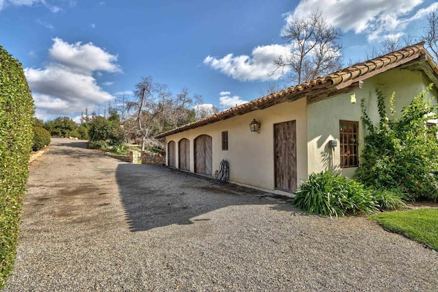 view of side of property with stucco siding