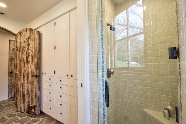 bathroom featuring stone finish flooring and visible vents