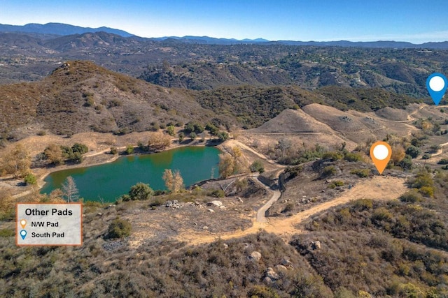 aerial view featuring a water and mountain view