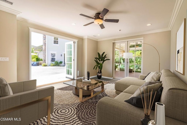 living room with crown molding, a healthy amount of sunlight, and ceiling fan