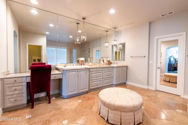 bathroom featuring walk in shower and vanity