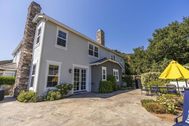 back of property with french doors and a patio area