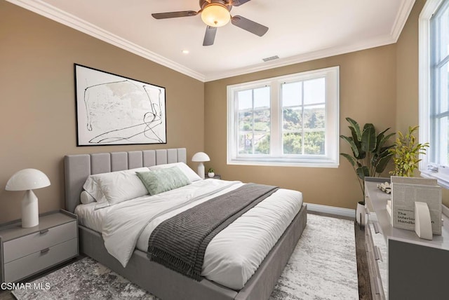 bedroom with crown molding, ceiling fan, and hardwood / wood-style flooring