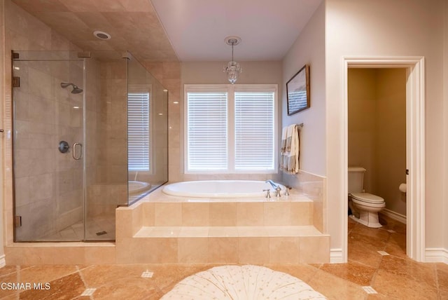 bathroom with shower with separate bathtub, a notable chandelier, and toilet