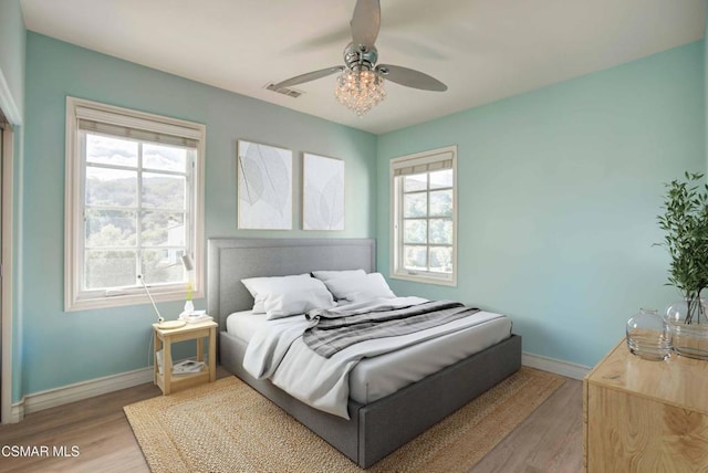 bedroom with ceiling fan and light hardwood / wood-style flooring