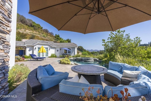 view of patio featuring an outdoor hangout area and an in ground hot tub