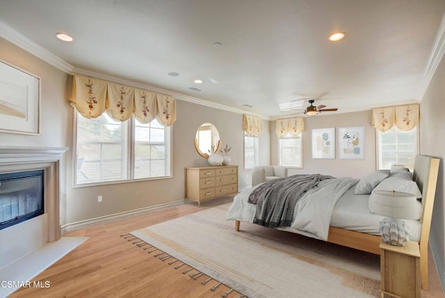 bedroom with hardwood / wood-style floors and ornamental molding