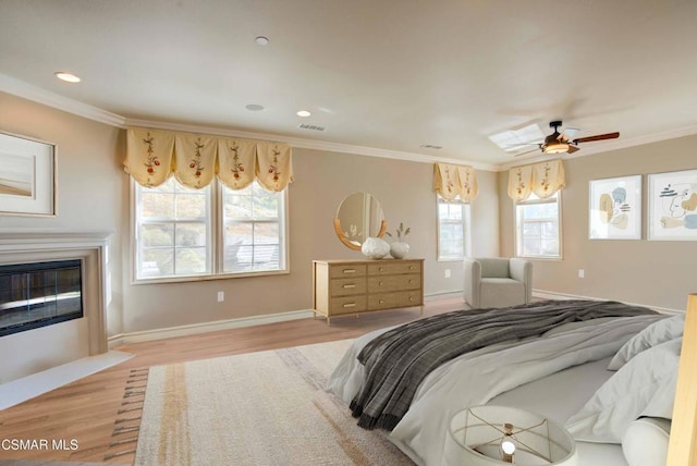 bedroom with ornamental molding and light hardwood / wood-style flooring