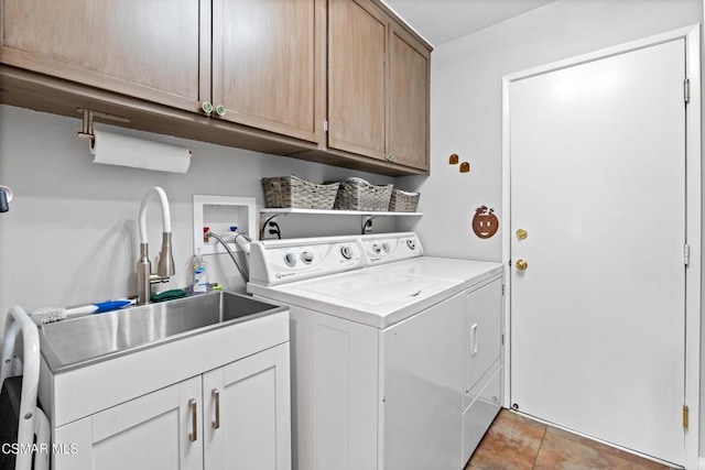 laundry room featuring cabinets, sink, and washer and dryer