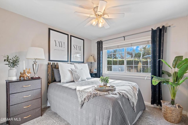 bedroom featuring light colored carpet and ceiling fan