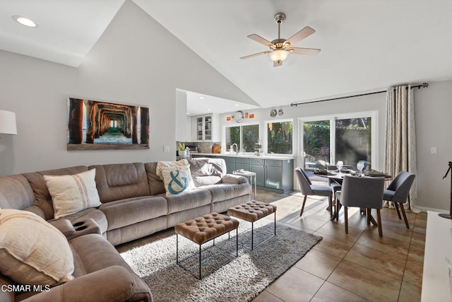 living room with ceiling fan, sink, light tile patterned floors, and high vaulted ceiling