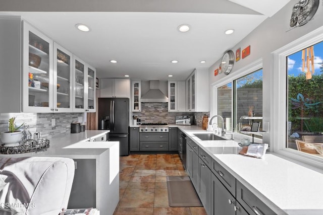 kitchen with sink, gray cabinetry, wall chimney exhaust hood, and black appliances