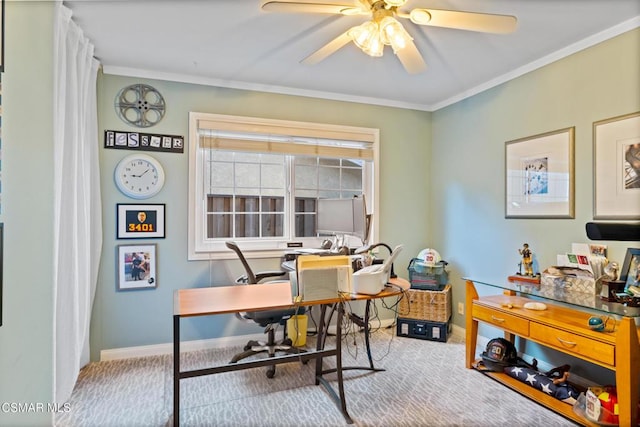 carpeted home office featuring crown molding and ceiling fan